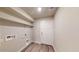 The laundry room has wood-look flooring, storage shelves, and utility hookups at 2509 W Seaver Ave, Apache Junction, AZ 85120