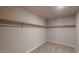 Walk-in closet featuring neutral carpet and open hanging storage at 2509 W Seaver Ave, Apache Junction, AZ 85120