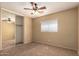 Bedroom with neutral carpet, closet, bright window, and a ceiling fan at 252 S Canfield --, Mesa, AZ 85208
