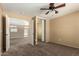 Bedroom with mirrored closet, neutral walls, ceiling fan, and adjacent open archway at 252 S Canfield --, Mesa, AZ 85208