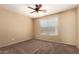Cozy bedroom featuring neutral carpet, a ceiling fan, and a bright window at 252 S Canfield --, Mesa, AZ 85208