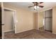 Comfortable bedroom features ceiling fan, mirrored closet, and convenient access to hallway at 252 S Canfield --, Mesa, AZ 85208