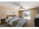 Cozy bedroom with natural light, ceiling fan, and a sliding glass door leading to the backyard at 252 S Canfield --, Mesa, AZ 85208