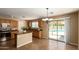 Bright kitchen with a center island, oak cabinets, and a view of the backyard pool through sliding glass doors at 252 S Canfield --, Mesa, AZ 85208