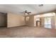 Open-concept living room boasts natural light and neutral tones, leading to kitchen and patio at 252 S Canfield --, Mesa, AZ 85208