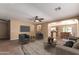 Open floor plan living room showcasing stylish decor, ceiling fan, and seamless flow to dining area at 252 S Canfield --, Mesa, AZ 85208