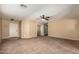 Spacious living area with a ceiling fan and neutral carpet, perfect for relaxation and gatherings at 252 S Canfield --, Mesa, AZ 85208