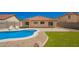 Backyard oasis with a sparkling pool, patio, and green turf in a securely fenced yard at 252 S Canfield --, Mesa, AZ 85208