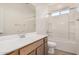 Clean bathroom featuring a shower-tub combo, wooden vanity, and modern faucet fixtures at 25308 N 133Rd Ave, Peoria, AZ 85383