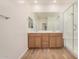 Bathroom featuring double sink vanity and seamless glass shower at 25308 N 133Rd Ave, Peoria, AZ 85383