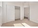 Bright bedroom features neutral carpet, a spacious closet and adjoining room for versatile living at 25308 N 133Rd Ave, Peoria, AZ 85383