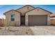 Charming single-story home with a two-car garage, desert landscaping, and a welcoming front entrance at 25308 N 133Rd Ave, Peoria, AZ 85383