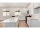 Modern kitchen featuring an island, stainless steel appliances, white cabinets, and tile flooring at 25308 N 133Rd Ave, Peoria, AZ 85383