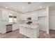Stylish kitchen with white cabinetry, stainless steel appliances, an island, and an open layout at 25308 N 133Rd Ave, Peoria, AZ 85383
