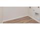 A minimalistic laundry room shows wood-style flooring and hookups for a washer and dryer at 25308 N 133Rd Ave, Peoria, AZ 85383