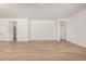 Open-concept living area with wood-look tile flooring, neutral paint, and ample space for entertaining at 25308 N 133Rd Ave, Peoria, AZ 85383