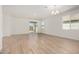 Spacious living room with wood-look tile flooring, abundant natural light, and smooth walls at 25308 N 133Rd Ave, Peoria, AZ 85383