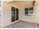 A cozy outdoor patio featuring concrete flooring, a large sliding glass door, and a window at 25308 N 133Rd Ave, Peoria, AZ 85383