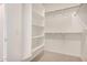 Walk-in closet features white shelving and clothing racks at 25308 N 133Rd Ave, Peoria, AZ 85383