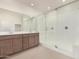 Bathroom showcasing double sinks, wood cabinets, and a spacious glass shower at 25314 N 133Rd Ave, Peoria, AZ 85383