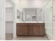Bathroom featuring dual sinks, a vanity with wood cabinets, and a walk-in shower at 25314 N 133Rd Ave, Peoria, AZ 85383