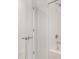 Bright bathroom featuring a bathtub with chrome fixtures and white tiled walls at 25314 N 133Rd Ave, Peoria, AZ 85383