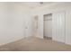 Bedroom featuring carpet, access to a closet, and an adjacent room at 25314 N 133Rd Ave, Peoria, AZ 85383
