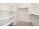 Spacious walk-in closet equipped with built-in shelving and neutral carpet at 25314 N 133Rd Ave, Peoria, AZ 85383