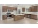 Modern kitchen featuring stainless steel appliances and a center island with countertops at 25314 N 133Rd Ave, Peoria, AZ 85383