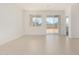 Bright, airy living room with neutral tile flooring and sliding glass door access at 25314 N 133Rd Ave, Peoria, AZ 85383