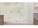 Large walk-in shower featuring a glass door, bench seat, and dual showerheads at 25314 N 133Rd Ave, Peoria, AZ 85383