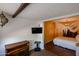 This cozy bedroom features a decorative lantern, a mounted TV, and an elevated bed at 2605 W Rose Ln # B-202, Phoenix, AZ 85017
