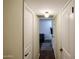 Hallway with white doors that lead to a living area with cozy furniture and interior design at 2605 W Rose Ln # B-202, Phoenix, AZ 85017