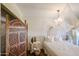 Serene main bedroom with a white bed and linens, decorative screen, and brick wall at 2605 W Rose Ln # B-202, Phoenix, AZ 85017