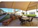 Outdoor grilling area with a built-in grill, table, and chairs for community gatherings at 2605 W Rose Ln # B-202, Phoenix, AZ 85017