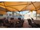 Community pool area featuring shaded seating, lounge chairs and well-maintained landscaping at 2605 W Rose Ln # B-202, Phoenix, AZ 85017