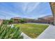 Lush backyard with green grass, mature trees, and secure pool fencing, creating a serene outdoor space at 277 W Glacier Bay Dr, San Tan Valley, AZ 85140