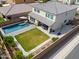 Aerial view of a spacious backyard featuring a pool, lush lawn, and covered patio area at 277 W Glacier Bay Dr, San Tan Valley, AZ 85140