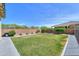 Spacious backyard with healthy green lawn and mature landscape elements creating an oasis at 277 W Glacier Bay Dr, San Tan Valley, AZ 85140