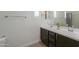Bright bathroom with dark vanity, double sinks and neutral decor, creating a clean and modern space at 277 W Glacier Bay Dr, San Tan Valley, AZ 85140