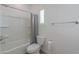 Well-lit bathroom features a shower-tub combo with modern fixtures and a sleek, white toilet at 277 W Glacier Bay Dr, San Tan Valley, AZ 85140