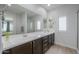 Bathroom featuring double sinks, ample counter space and a large mirror at 277 W Glacier Bay Dr, San Tan Valley, AZ 85140