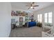 Bright bedroom with a twin bed, neutral walls, and a ceiling fan, creating a cozy and functional space at 277 W Glacier Bay Dr, San Tan Valley, AZ 85140