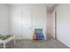 Bright bedroom with a simple desk, white walls, and carpeted floor, creating a clean and versatile space at 277 W Glacier Bay Dr, San Tan Valley, AZ 85140