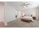 Spacious bedroom with a ceiling fan and a bathroom with a sliding barn door at 277 W Glacier Bay Dr, San Tan Valley, AZ 85140