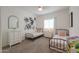 Bright bedroom with two twin beds, white walls, and a window, creating a cozy and inviting space at 277 W Glacier Bay Dr, San Tan Valley, AZ 85140