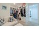 Walk-in closet providing ample storage with custom shelving and a seating area at 277 W Glacier Bay Dr, San Tan Valley, AZ 85140