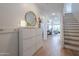 Bright entryway featuring tile floors, white walls, modern storage solutions, and staircase access at 277 W Glacier Bay Dr, San Tan Valley, AZ 85140