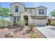 Charming two-story home with a well-manicured front yard, desert landscaping, and a two-car garage at 277 W Glacier Bay Dr, San Tan Valley, AZ 85140