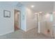 Bright hallway with carpet flooring leading to various rooms, showcasing the home's open layout at 277 W Glacier Bay Dr, San Tan Valley, AZ 85140